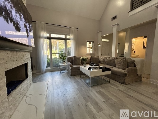 A living room with a fireplace and a couch.