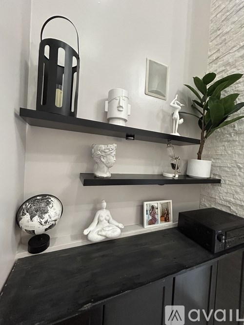 A black shelf with various objects on it.