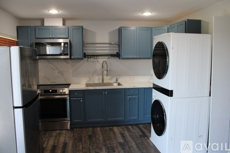 A kitchen with a white refrigerator and a black oven.