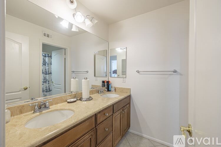 A bathroom with a sink, mirror, and towel rack.