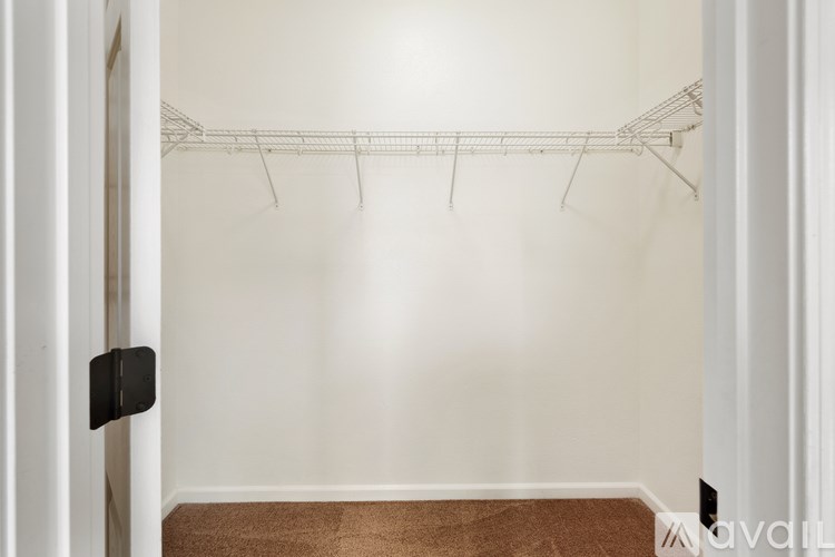 A white wall with a metal rack on it.