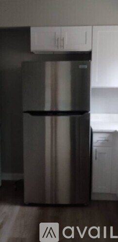 A stainless steel refrigerator in a kitchen.
