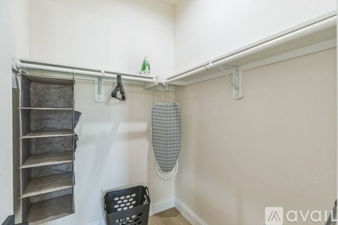 A laundry room with a washing machine and a dryer hanging on the wall.