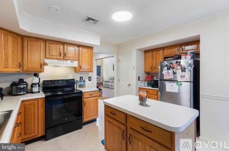 A kitchen with wooden cabinets and a black stove top oven.