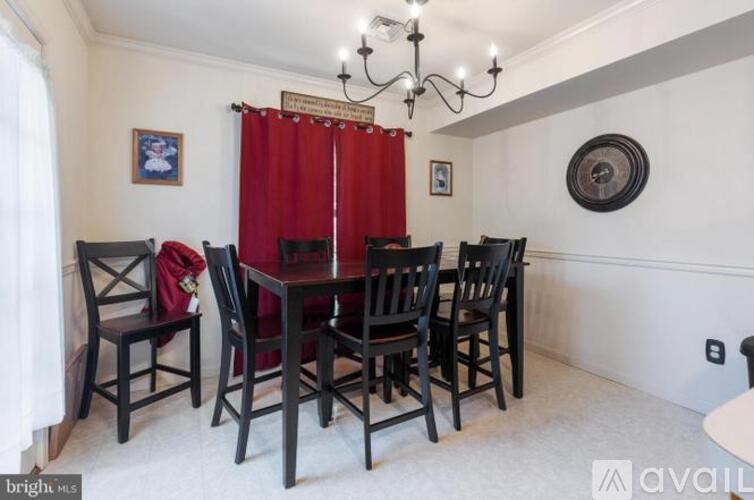A dining room with a table set for six.