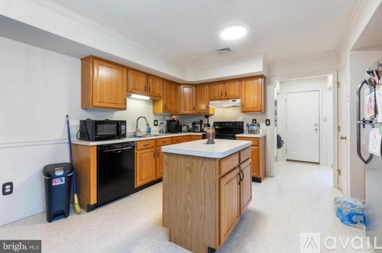 A kitchen with wooden cabinets and a white countertop.