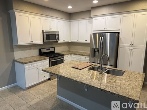 A kitchen with granite countertops and stainless steel appliances.