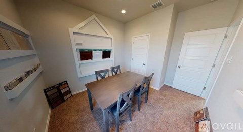 A dining room with a table and chairs.