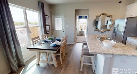 A kitchen with a table and chairs is available for rent.