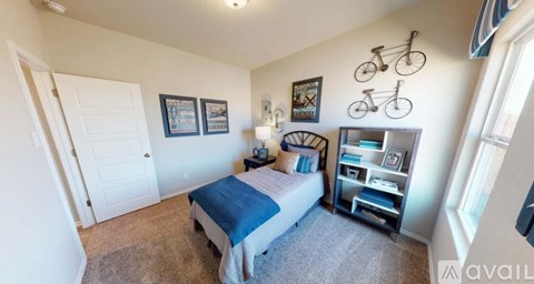 A bedroom with a bed, nightstand, and a bicycle decoration on the wall.