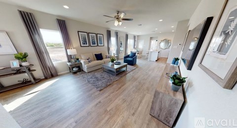 A spacious living room with a large wooden floor and a variety of furniture.