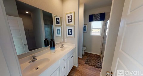 A bathroom with a white sink and a mirror above it.