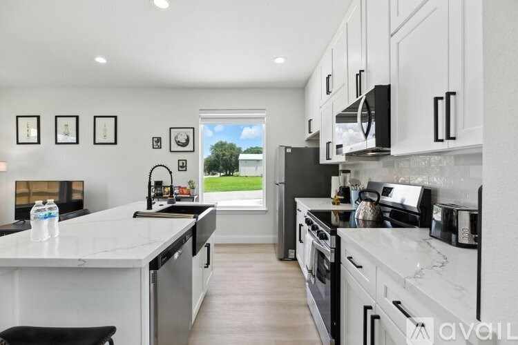 A modern kitchen with a view of the backyard.