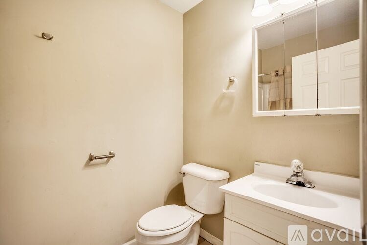 A white toilet sits next to a sink in a bathroom.
