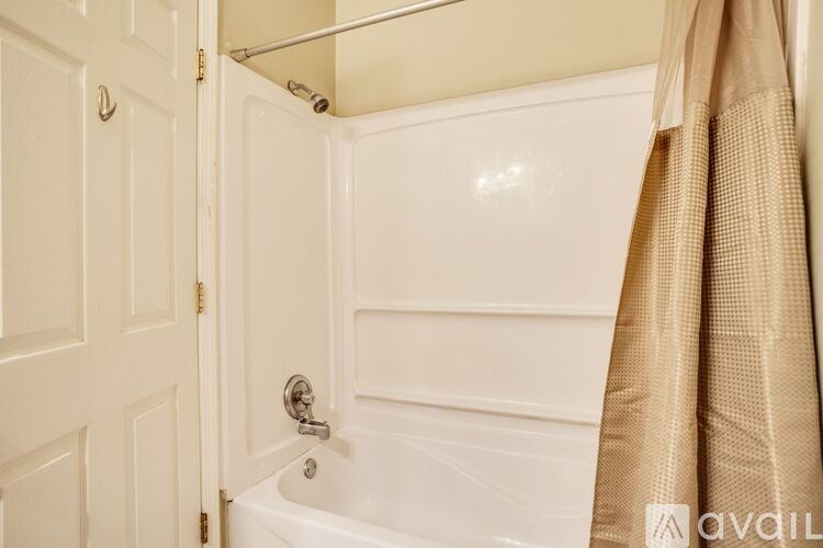 A white bathroom with a shower curtain.