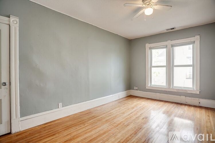 A room with a wooden floor and a window.