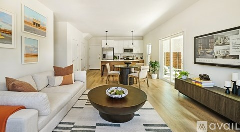 A living room with a white couch and a coffee table in the center.