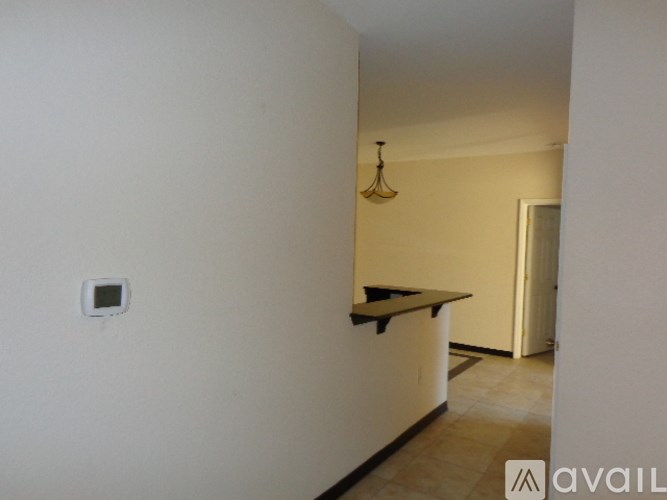 A small kitchen with a counter and a hanging light fixture.