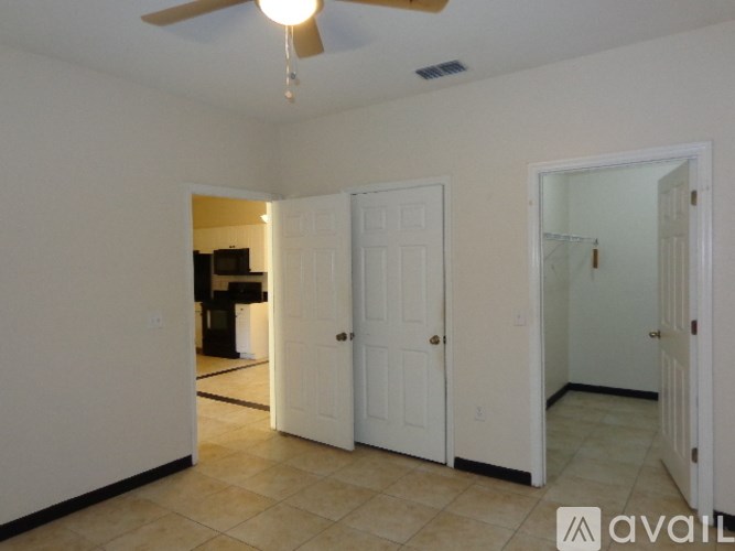A room with a ceiling fan and a tiled floor.