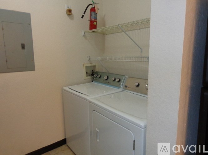 A white oven and microwave in a small kitchen.