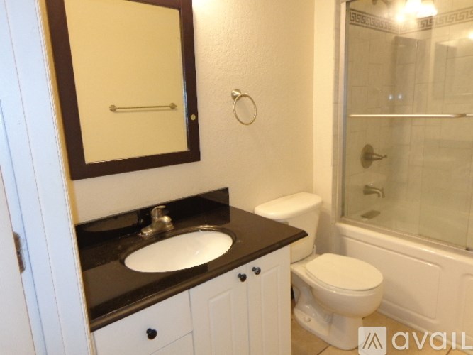 A bathroom with a sink, toilet, and bathtub.