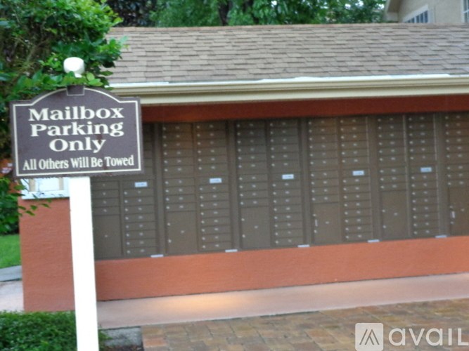 A sign in front of a mailbox indicates that the parking is for mailboxes only.