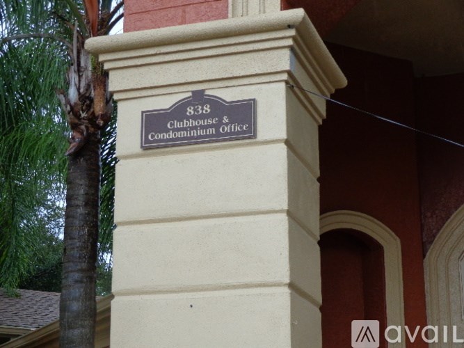 A sign for the 838 Clubhouse & Condominium Office is mounted on a column.