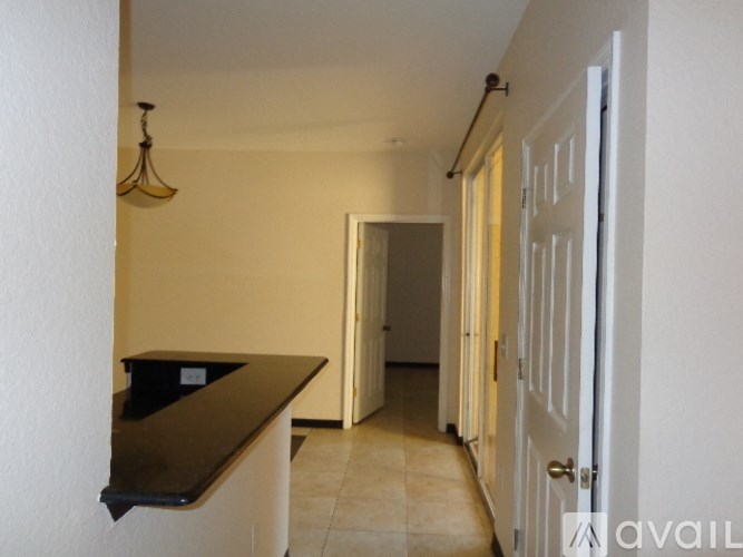 A room with a brown counter and a chandelier.