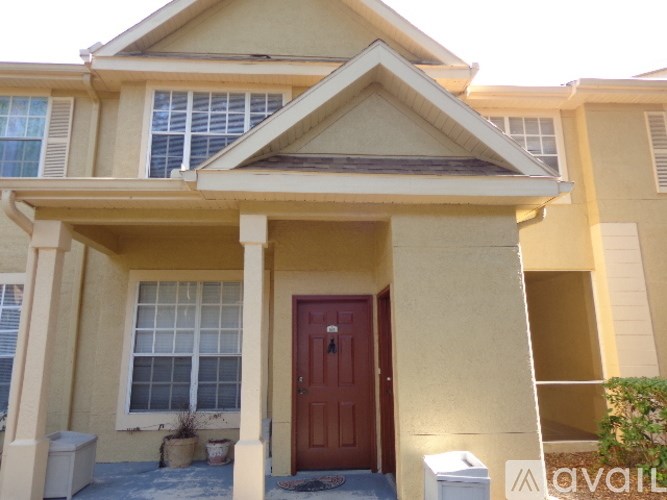 A house with a red door and a brown roof.