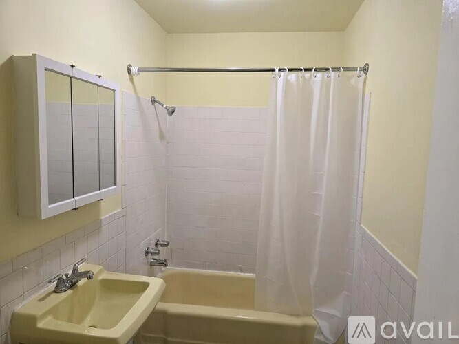 A bathroom with a shower curtain and a bathtub.