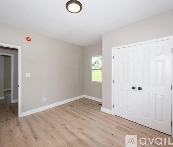 A room with a white door and a window.