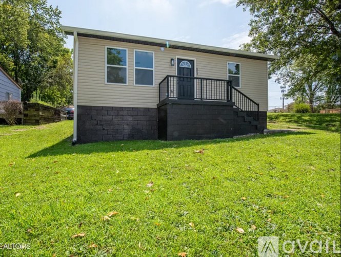 A small house with a black railing on the balcony.