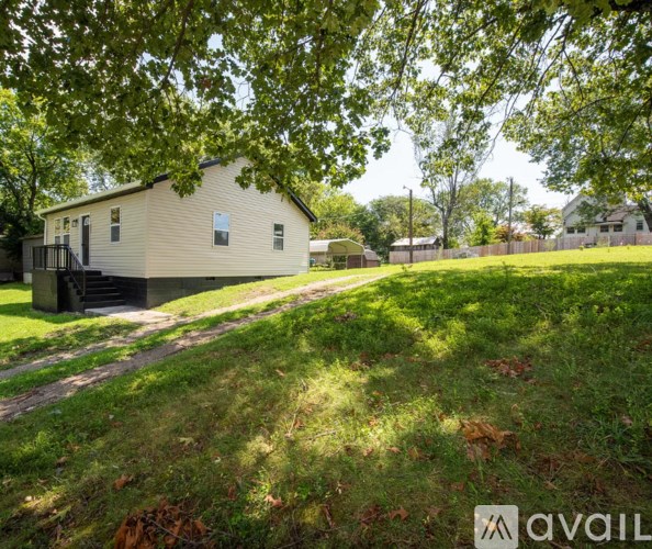 A house with a tree in front of it.