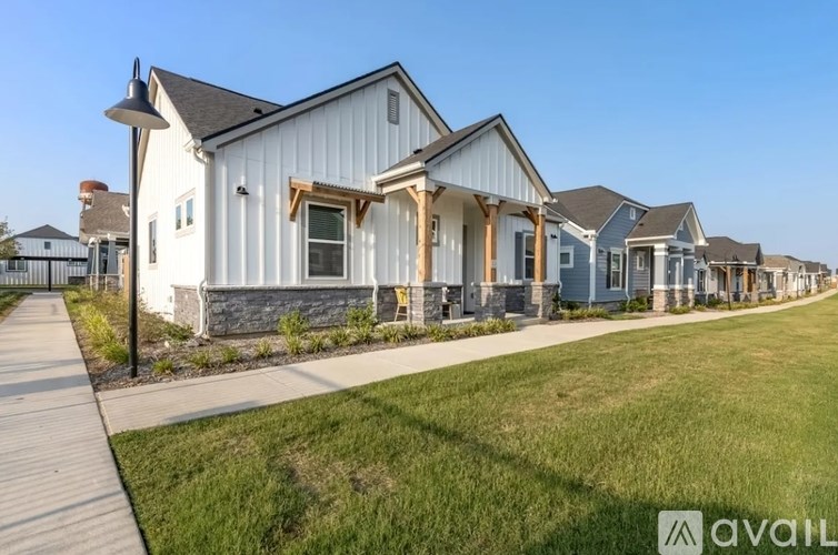 A row of houses with a clear blue sky above them.