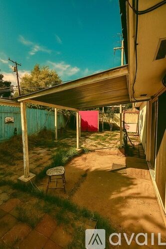 A patio with a red cloth and a chair.