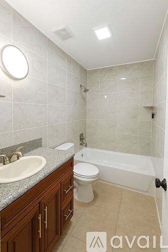 A bathroom with a sink, toilet and bathtub.