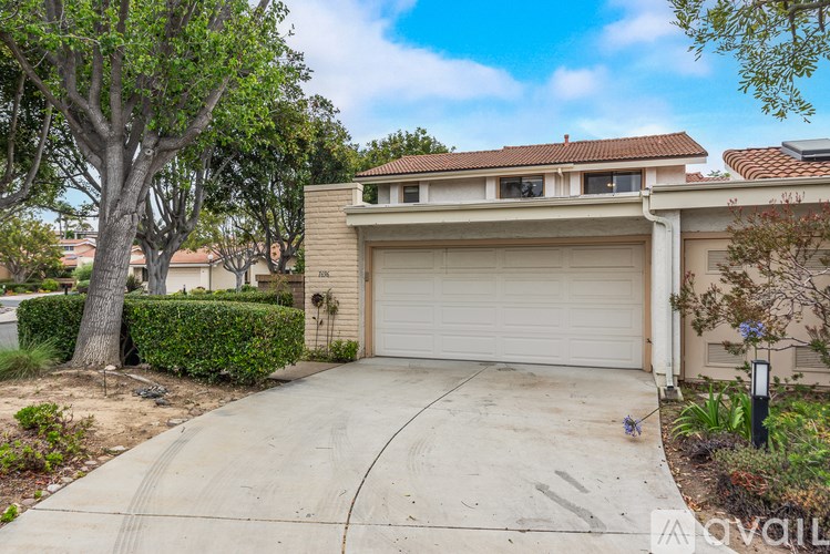 A house with a white garage door is for sale.