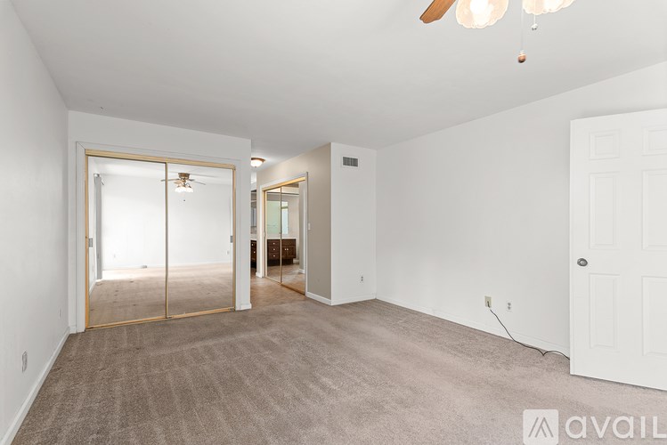A room with a carpeted floor and a sliding glass door.