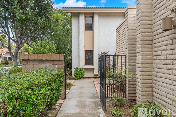 A small house with a black gate in front.