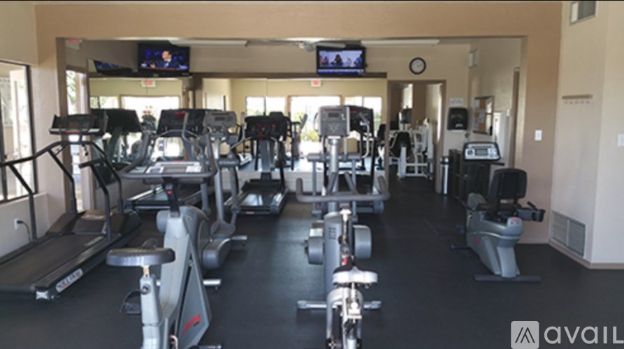 A gym with treadmills, exercise bikes, and other equipment.