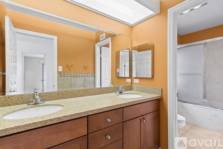 A bathroom with orange walls and a white door.