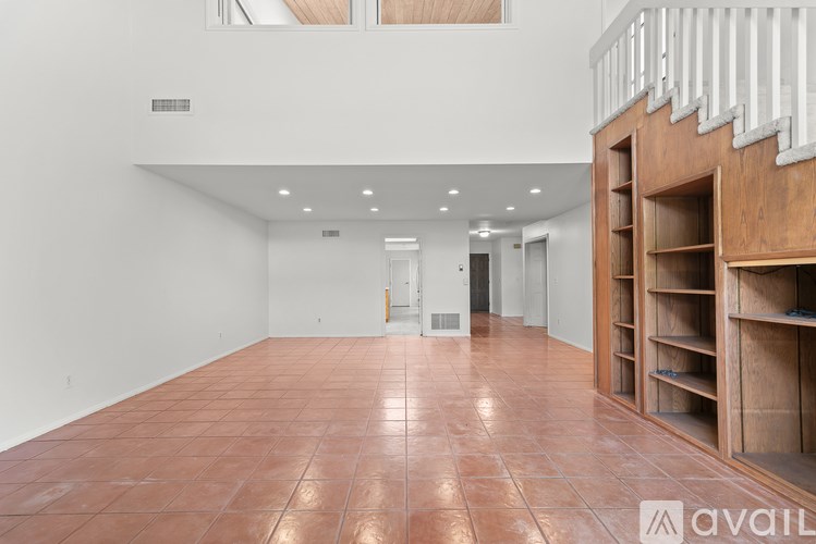 A large room with a brown floor and white walls.