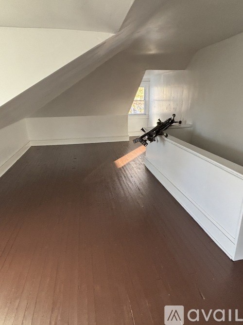 A room with wooden floors and white walls.