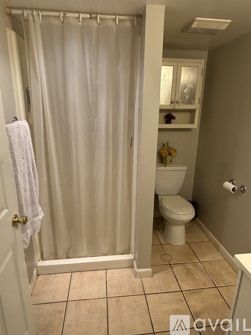 A bathroom with a towel hanging on the door.