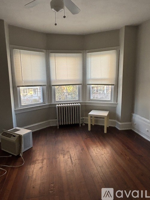 A room with a radiator and a fan.