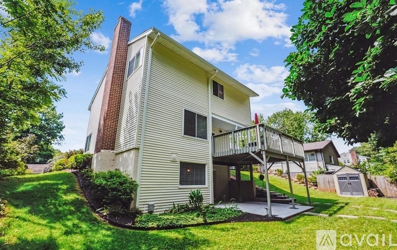 A house with a red brick chimney and a balcony.
