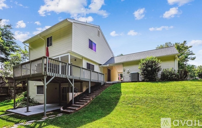 A house with a balcony and a staircase leading to the entrance.