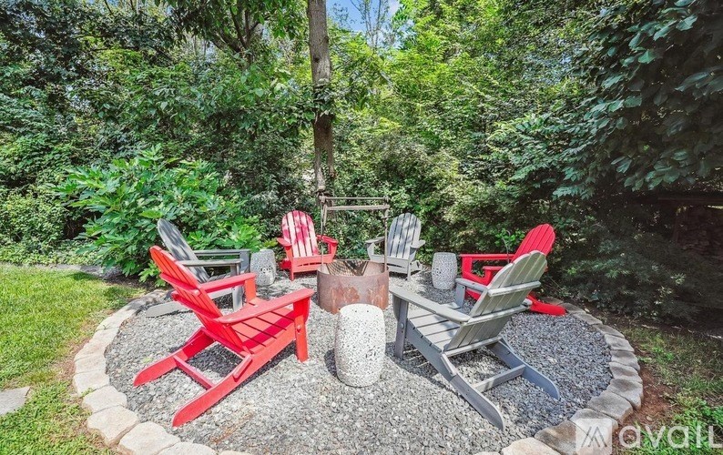 A red and grey patio set is set up in a garden.