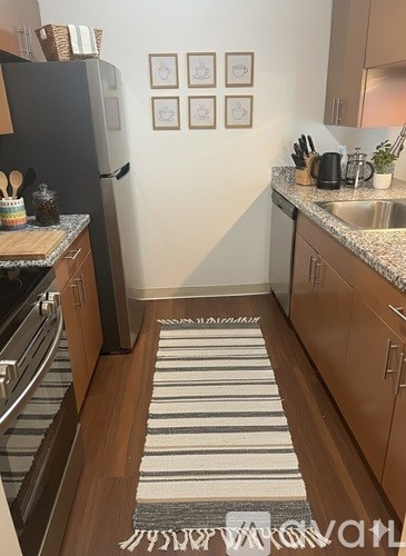 A kitchen with a striped rug on the floor.
