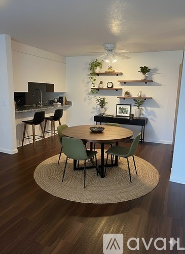A dining room with a round table and chairs.